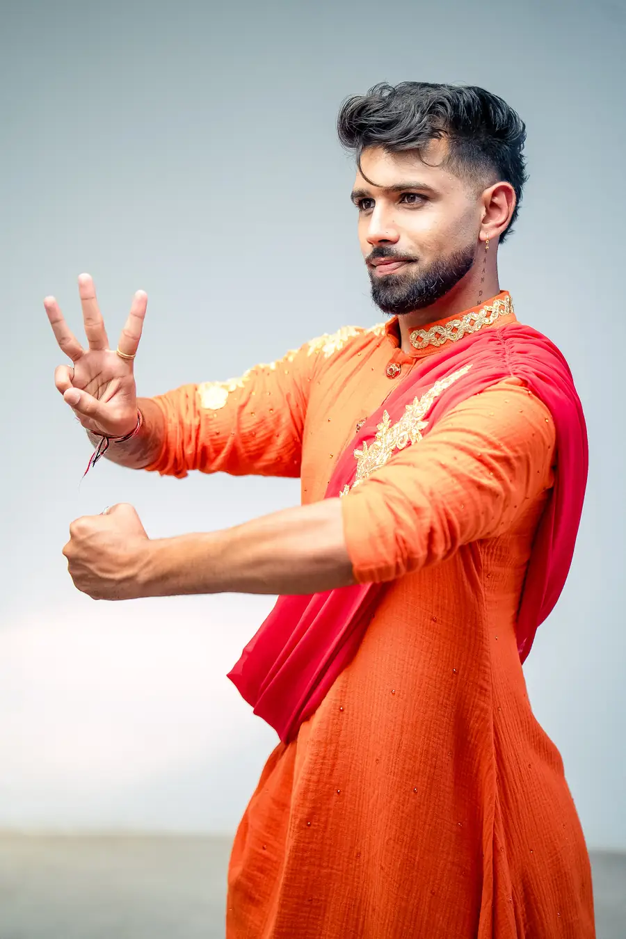 Jitesh Ranchod in an orange kurta and red dhoti