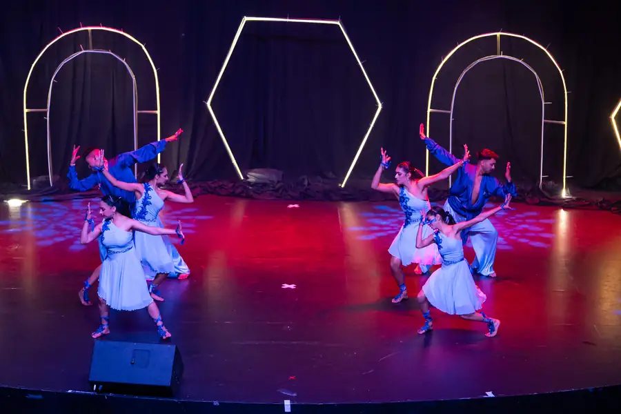 Group of dancers in colourful lehengas performing a Bollywood routine