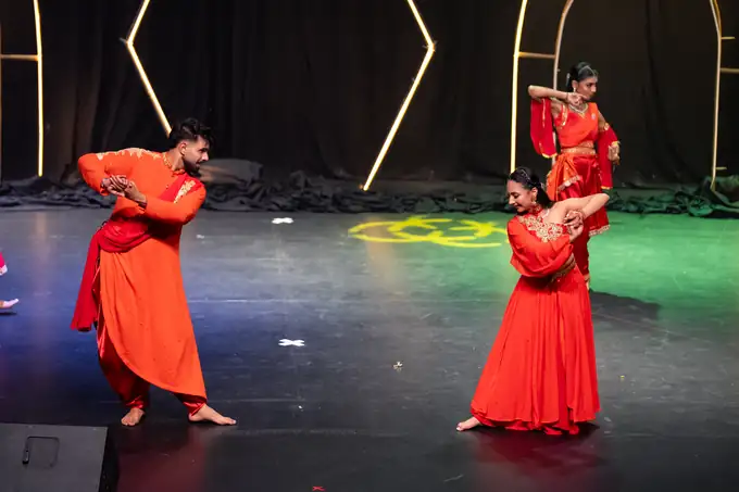 Soloist in a red flared skirt turning centre stage