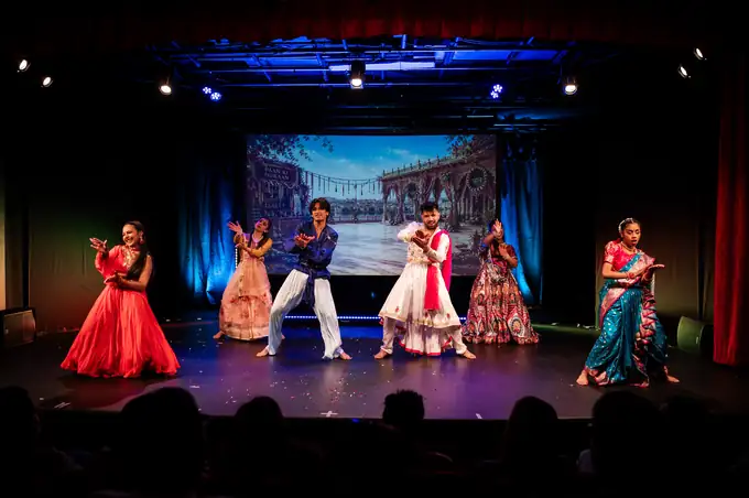 Kathak-inspired group in red and white flared skirts