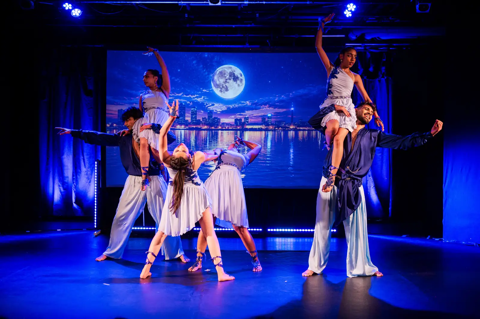 Dancers lifted in formation against a moonlit backdrop during Dil Se Bollywood